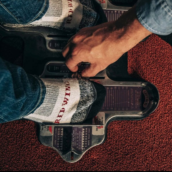 person wearing Red Wing socks being measured and fitted for new shoes
