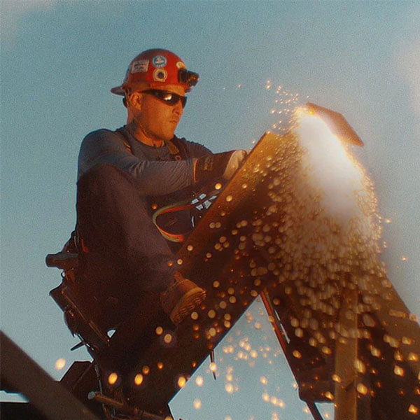 construction worker on a steel beam wearing safety boots