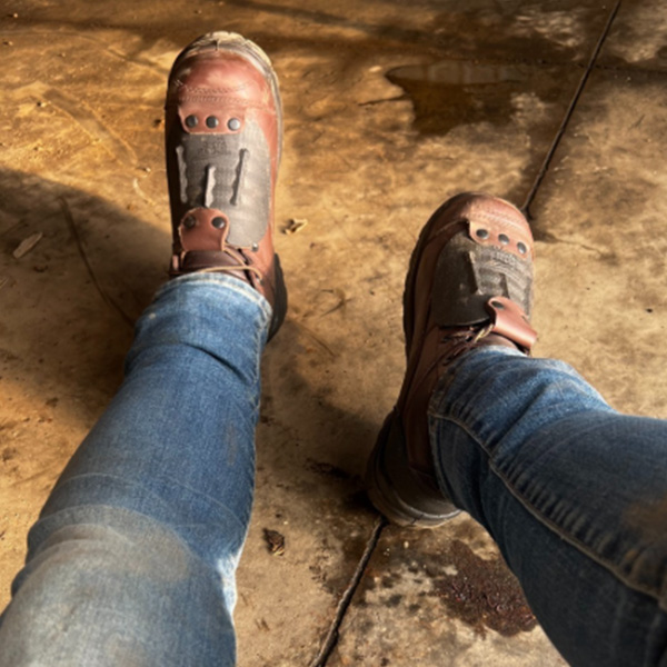 Men's boots inside barn